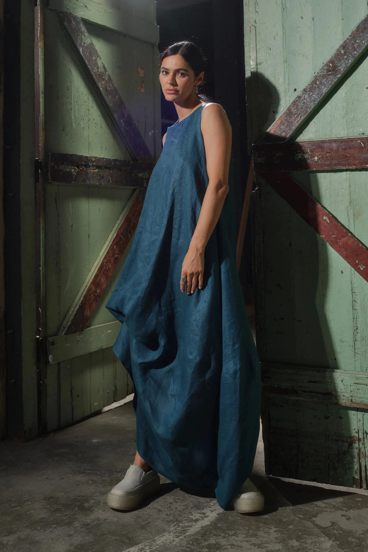 Front view of bold asymmetrical linen maxi dress in petroleum blue