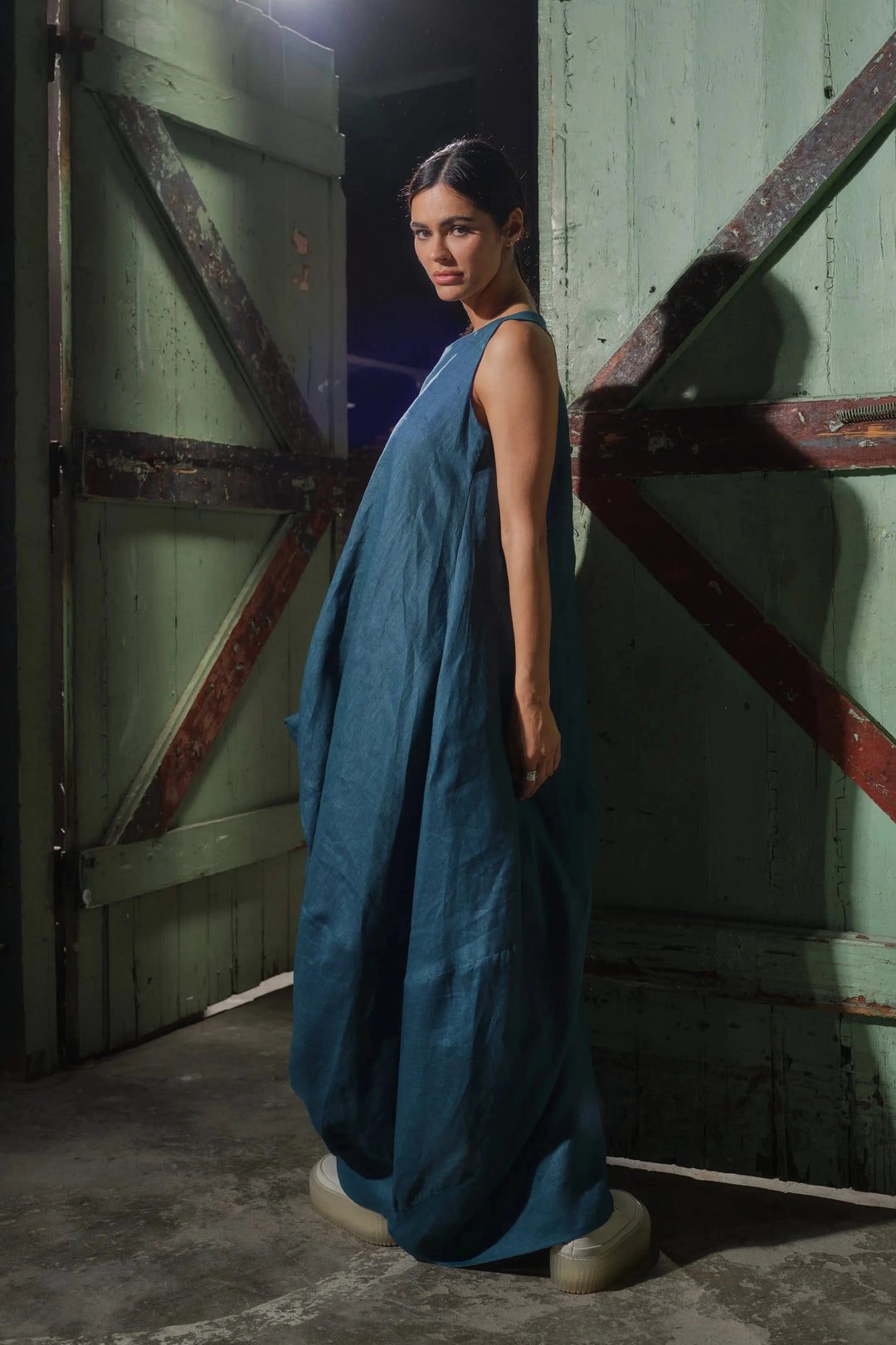 Side view of chic linen maxi dress with draped detailing