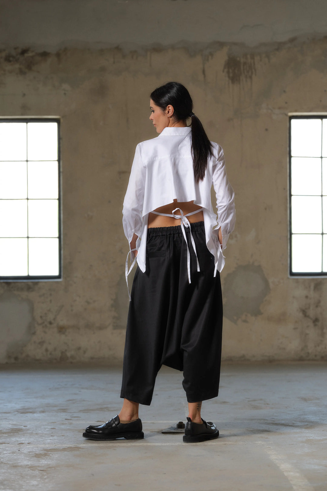 Black wool drop crotch winter pants with asymmetrical details