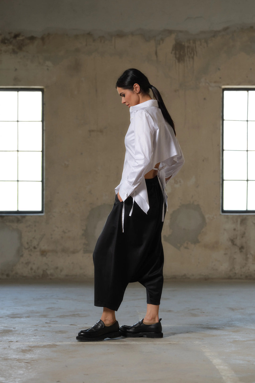 Black wool drop crotch winter pants with asymmetrical details