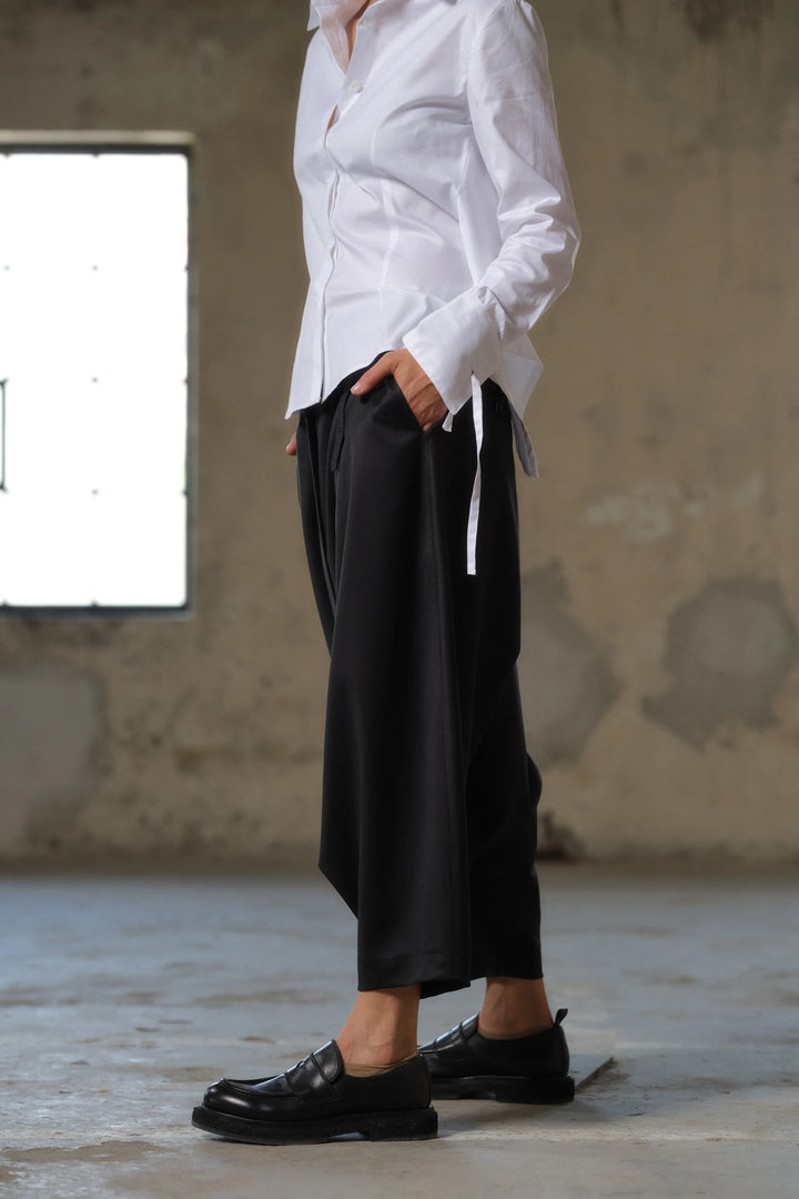 Black wool drop crotch winter pants with asymmetrical details