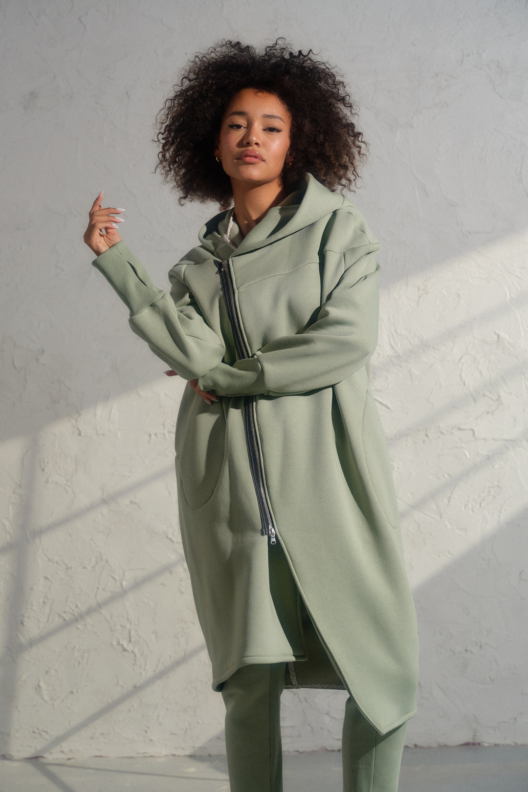 Asymmetrical organic cotton hoodie in Green Tea color