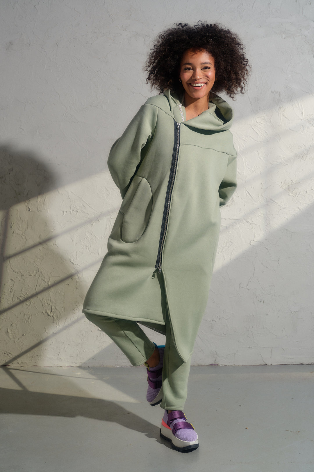 Asymmetrical organic cotton hoodie in Green Tea color